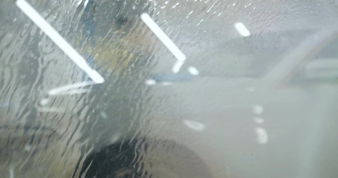 The professional washer by the windows of the car wash (in the car-care center) washes the window from a Karcher, and accessories for washing windows, is shown very close. Concept of: Detergents, Clea