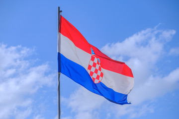 Scenic view of national flag of Croatia waving on wind. Beautiful view of symbol of old eastern european country in front of clear blue sky. 