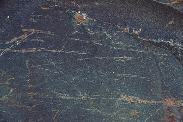 Plane of multicolored boulder in macro. Beautiful rock surface close up. Colorful textured stone. Amazing detailed background of highlands boulder with mosses and lichens. Natural texture of mountain.