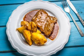 Grilled pork steak and fried potatoes