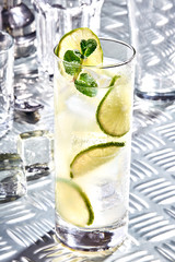 Caipirinha, Mojito cocktail, vodka or soda drink with lime, mint and straw on table
