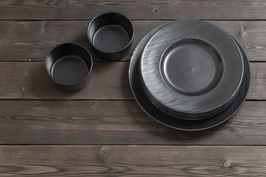 black plates on wooden background