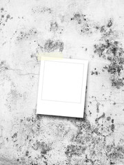 Blank square instant photo frame on grey concrete wall background