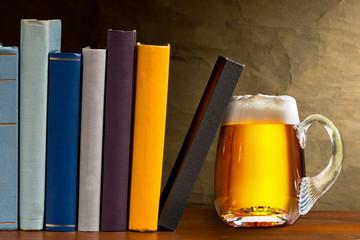 Glass of beer with books in the library