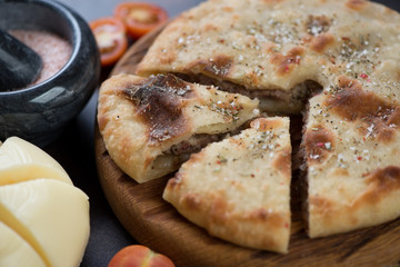 Sliced ossetian pie stuffed with meat, horizontal shot, close-up