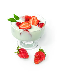 Strawberries with cream in a glass isolated on white