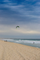 Vertical landscape of a beach in Perth in a cloudy day and a guy doing wind surf