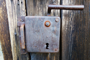 An old lock on a wooden door
