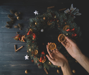 Natural Christmas wreath on black wooden background