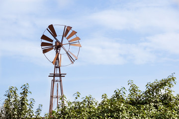 Vintage toned photo of an old western windmill tower, American wild west symbol .
