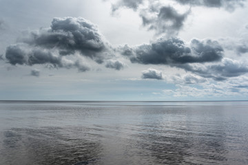 Naklejka na ściany i meble Scattered clouds over Baltic sea.