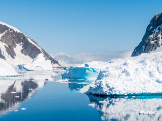 Fototapeta na wymiar Errera Channel with drifting icebergs and ice floes on a sunny day in antarctic summer, Antarctica