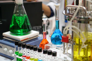 Magnetic laboratory agitators. The green liquid is mixed in a conical glass flask.