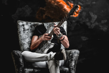evil, mad guitarist sitting on a black and silver chair, playing the instrument, fire and smoke comes out of the guitar's neck 