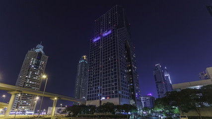 Fototapeta na wymiar Skyscrapers at the Sheikh Zayed Road at night in Dubai timelapse hyperlapse