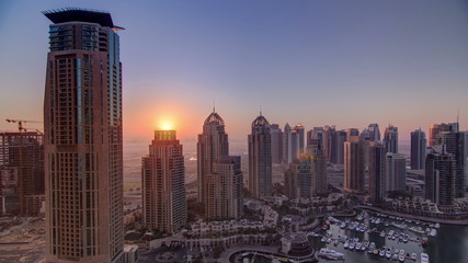 Fototapeta na wymiar Sunrise in Dubai Marina with towers and harbor with yacht from skyscrapper, Dubai, UAE timelapse 4K