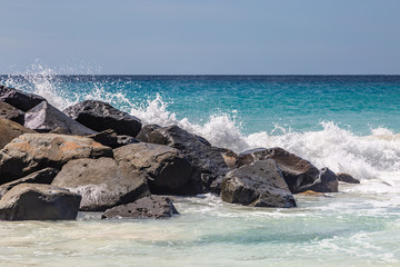Waves crashing over rocks on a beach, on the island of Barbados