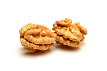 Two walnut kernels, close up macro, isolated on a white background.