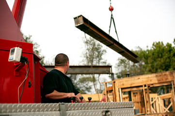 Fototapeta na wymiar hoisting a steel I-beam with a crane