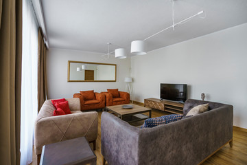 Interior of light spacious living room with a picturesque mountain and sea view in a luxury villa