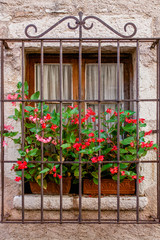 Fototapeta na wymiar Old stone building with wooden shutters - Mediterranean architecture