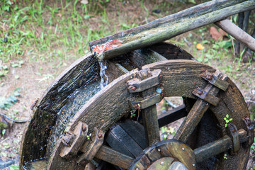old wooden waterwheel in the forest