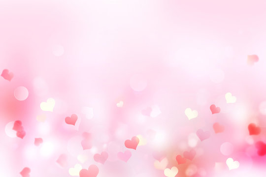 Valentine pink blurred hearts background.