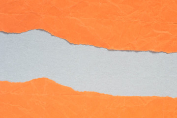 orange torn paper with copy space on gray background