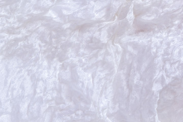 White wrinkled shabby natural old silk. Thin tissue. Silk fabric texture background. Shabby chic close up.