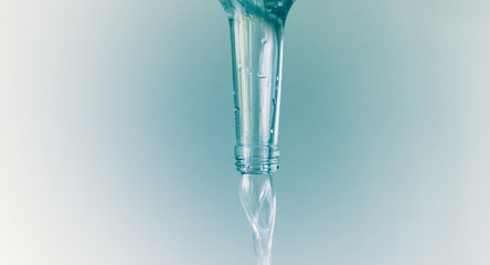 Neck of water bottle. Fresh water is poured out