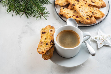Christmas homemade cookies biscotti with dry berries and cup of coffee.