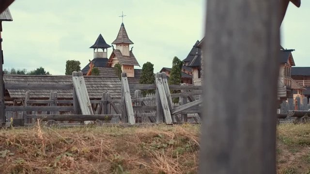 An ancient Slavic pagan city built of wood, excellent scenery for a historical film, old wooden churches and houses, an orthodox cross, summer time, no people in the frame, old Kiev