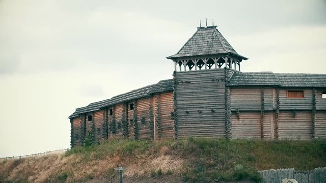 An ancient Slavic pagan city built of wood, excellent scenery for a historical film, old wooden churches and houses, an orthodox cross, summer time, no people in the frame, old Kiev