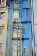 Old Frauenkirche church reflects into modern glass facade, Dresden, Germany.