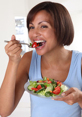 WOMAN EATING MIXED SALAD