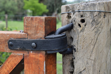 antique iron hinges on the gate at the entrance to the ranch