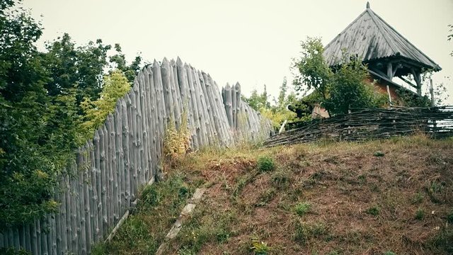 An ancient Slavic pagan city built of wood, excellent scenery for a historical film, old wooden churches and houses, an orthodox cross, summer time, no people in the frame, old Kiev