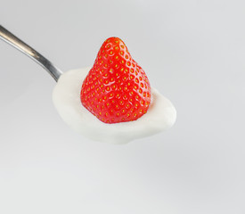 single fresh red strawberry on a light background
