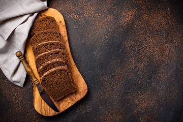 Fresh sliced rye bread on rusty background