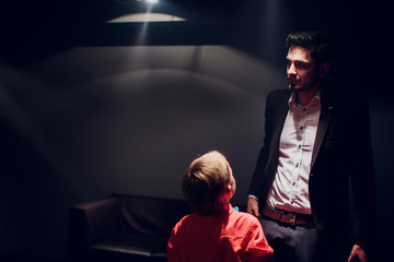 The entertainer. Young elegant talking man holding microphone