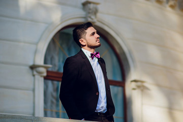 The entertainer. Young elegant talking man holding microphone