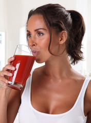 WOMAN DRINKING TOMATO JUICE