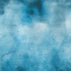 Blue watercolor winter texture with abstract washes and brush strokes on the white paper background.