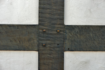 White wall detail decorated with wooden rafters