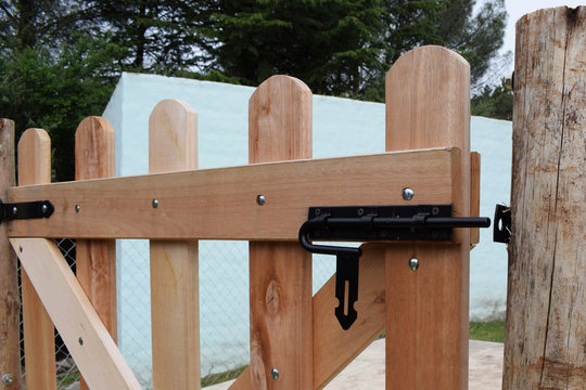 on the wooden gate to the entrance to the pool with an open lock