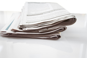Newspapers folded and stacked concept for global communications