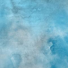 Blue watercolor winter texture with abstract washes and brush strokes on the white paper background.