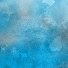 Blue watercolor winter texture with abstract washes and brush strokes on the white paper background.