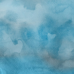 Blue watercolor winter texture with abstract washes and brush strokes on the white paper background.
