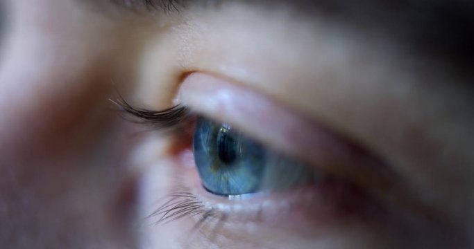 Close-up macro shot of young male human blue eye blinking in slow motion. Concept of moments of life, memory, eye care, optics., lens. Shot with RED 8K